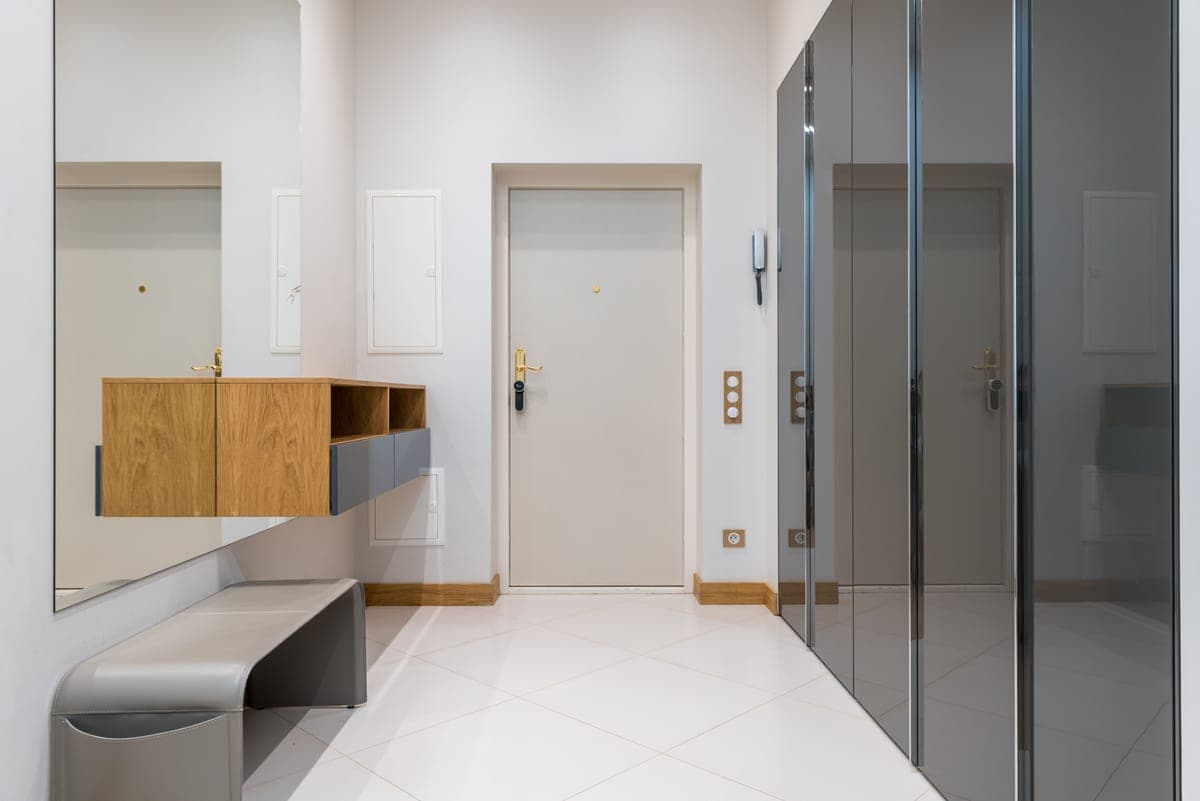 A bench, a shoe cabinet and an open rack compared in an entryway