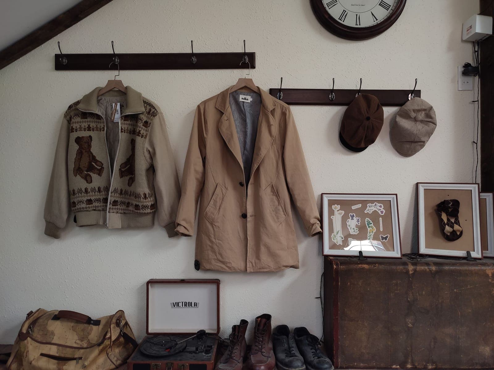Warm autumn coats and hats hanging from hangers on a wall by a home entrance