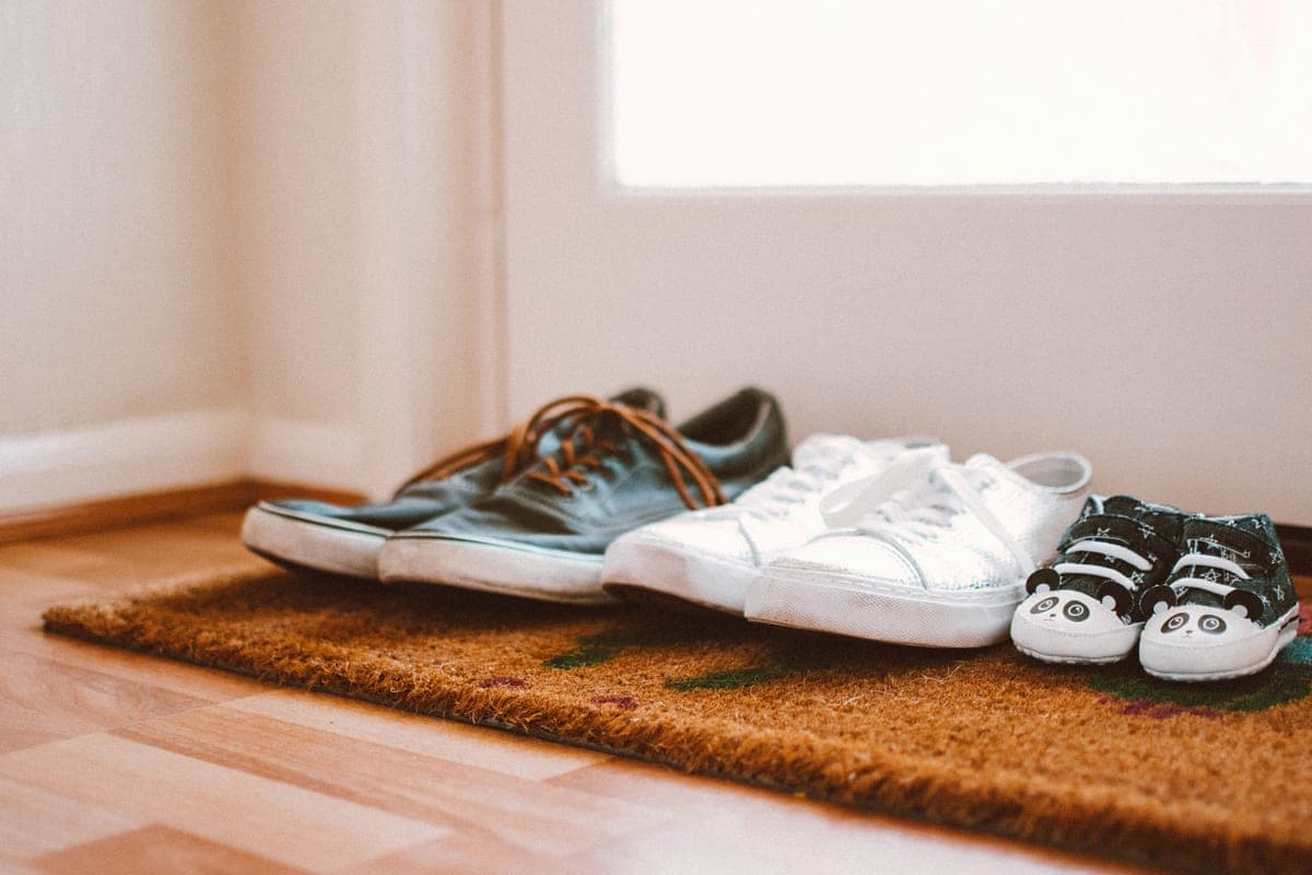 A door mat and a boot tray side by side in an entryway