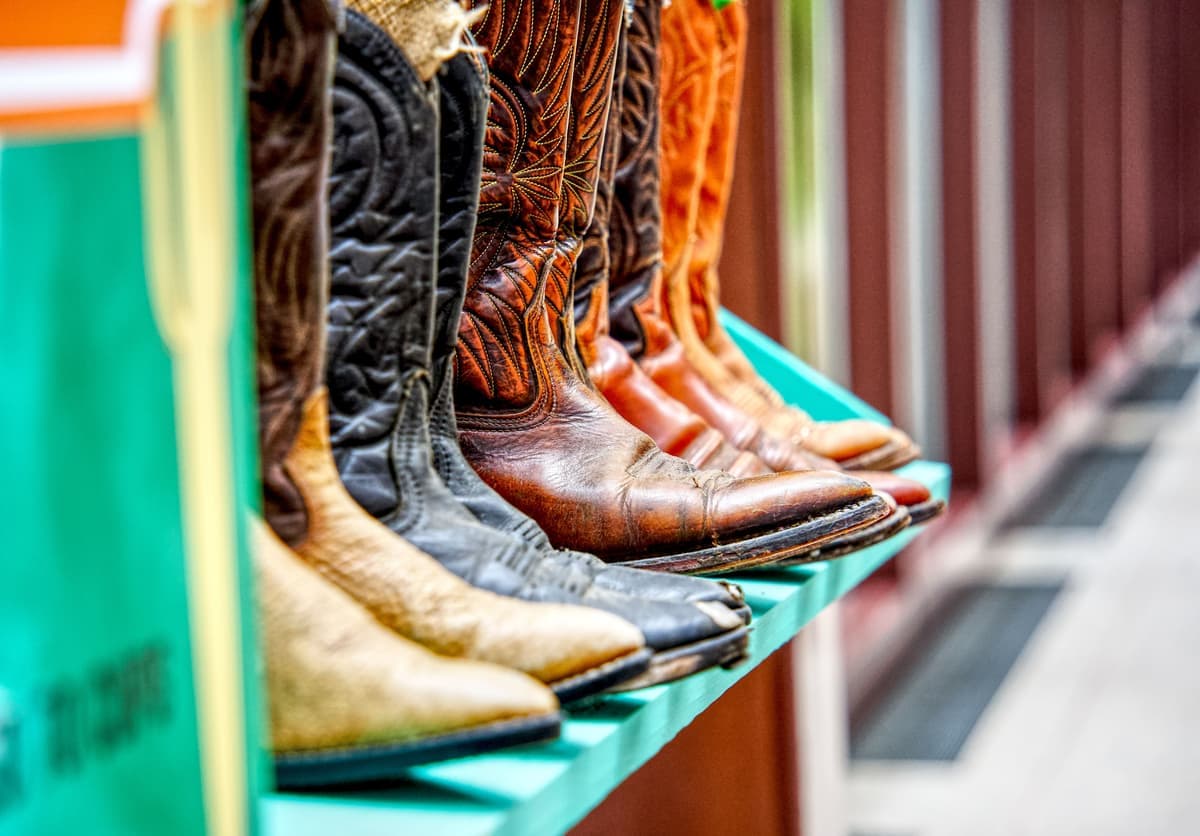 A rubber boot tray with raised edges holding a pair of wet boots
