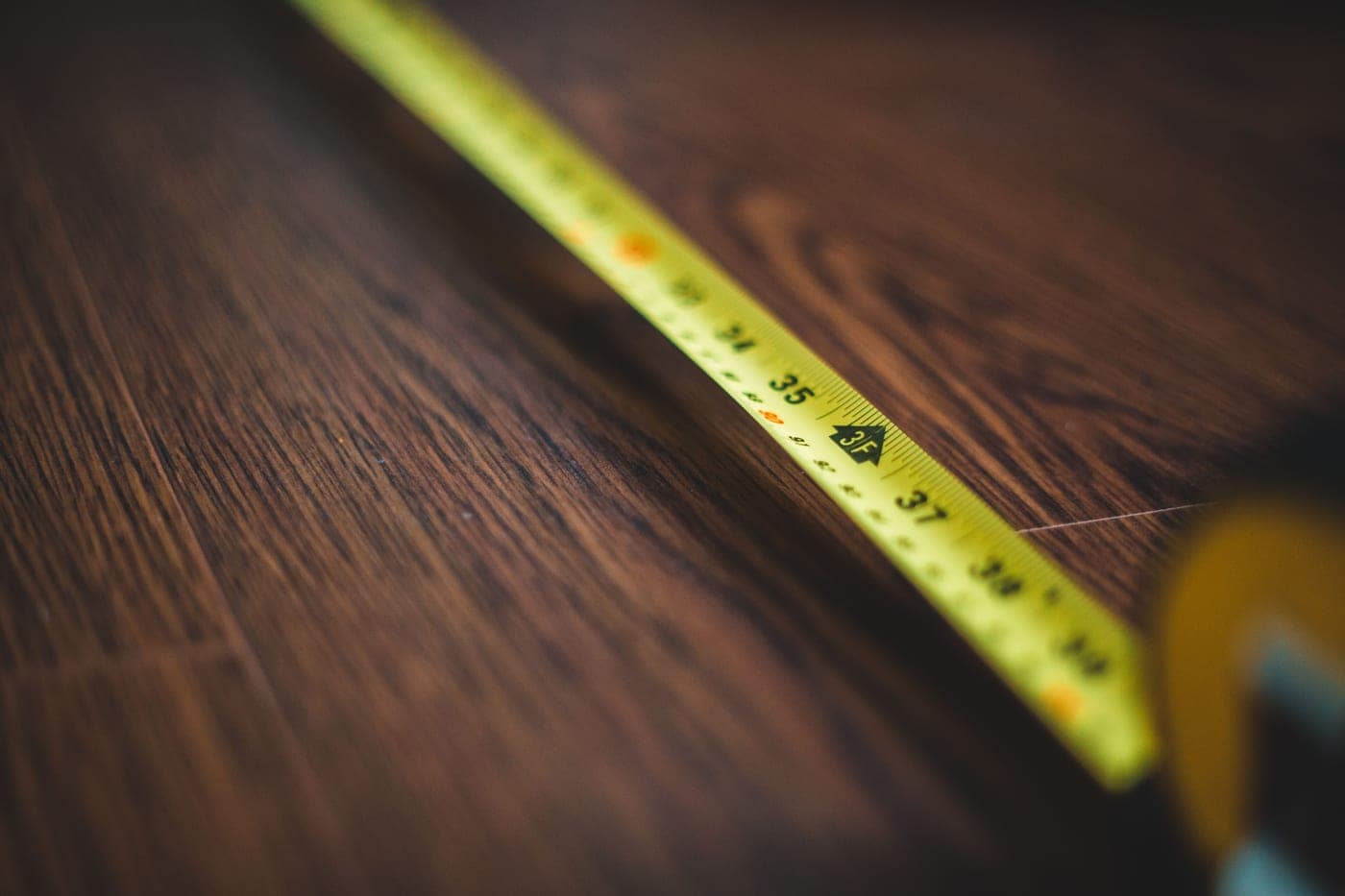 A measuring tape on a wooden floor